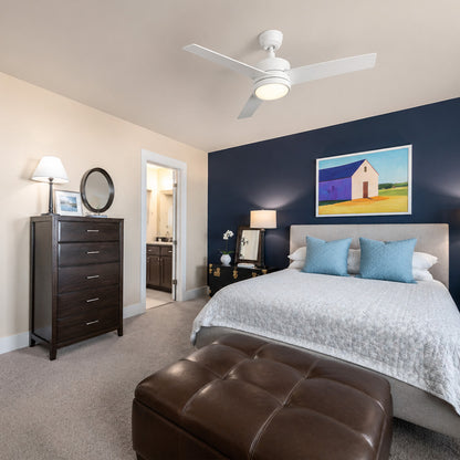 Modern bedroom with Smafan Louy 52" 3-blade ceiling fan with light, navy accent wall, upholstered bed, and clean decor. A bedroom ceiling fan with light in crisp white finish. 
