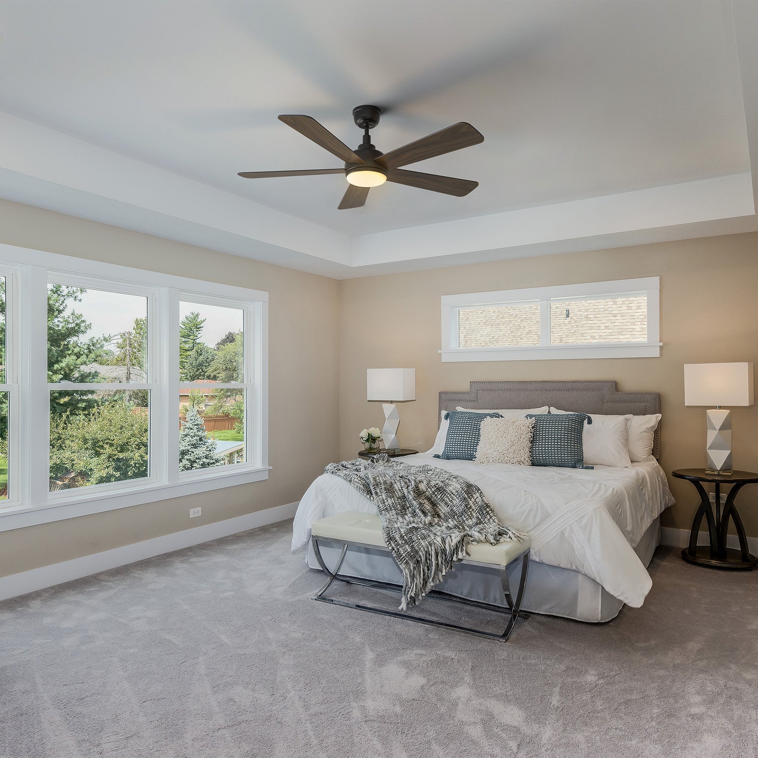 Smafan Toplam 52 inch wood ceiling fan with bright light in a traditional bedroom featuring a large bed with white linens, a white bench, matching nightstands with lamps, and large windows overlooking greenery. 
