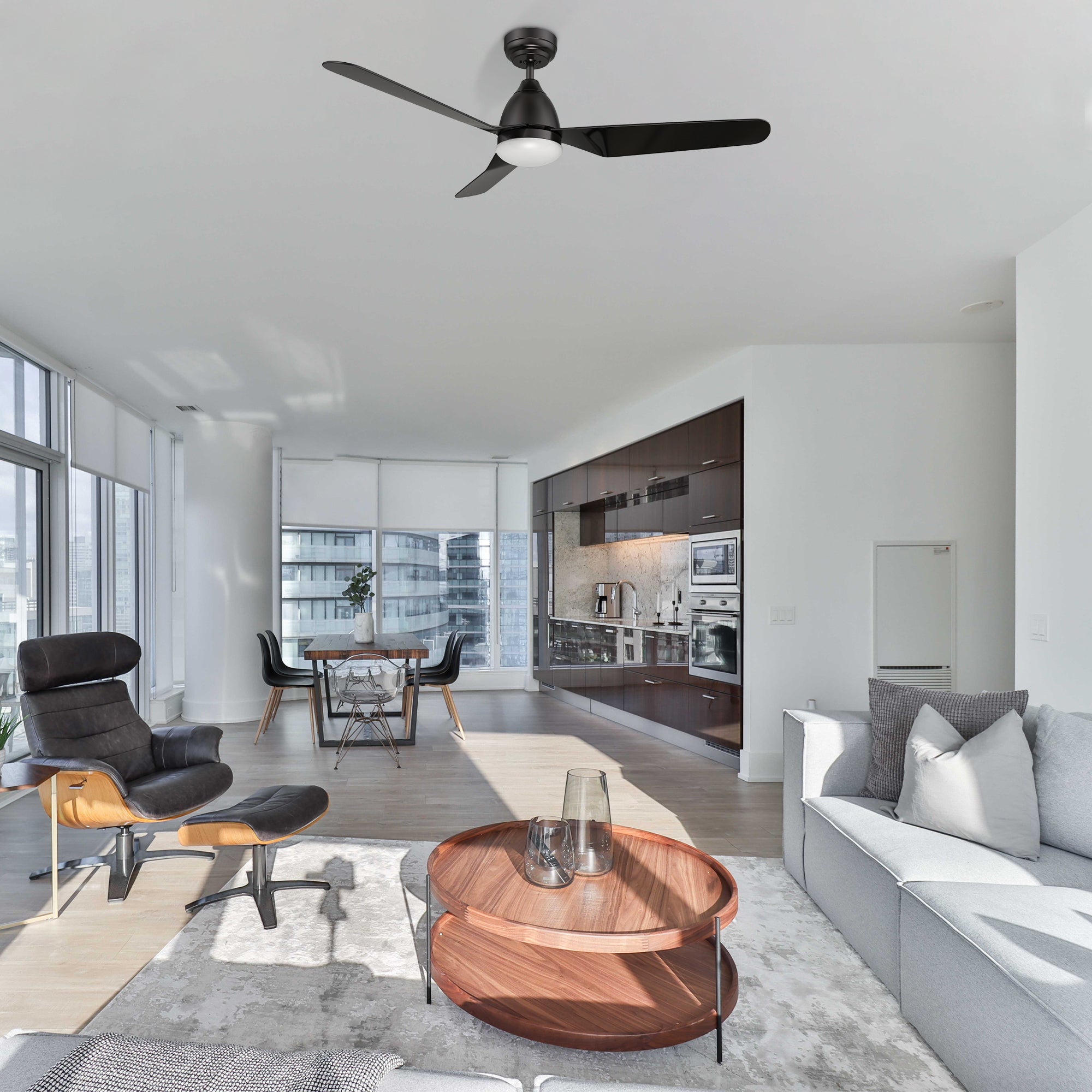 The Triton 52-inch smart ceiling fan elegantly complements a modern living room with contemporary furniture and bright natural lighting. 