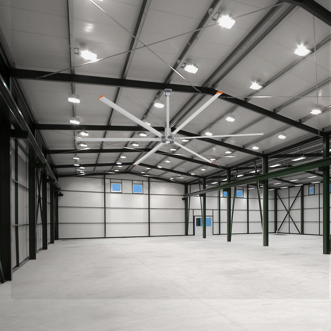 20 ft Industrial fan mounted on the ceiling of an empty warehouse.