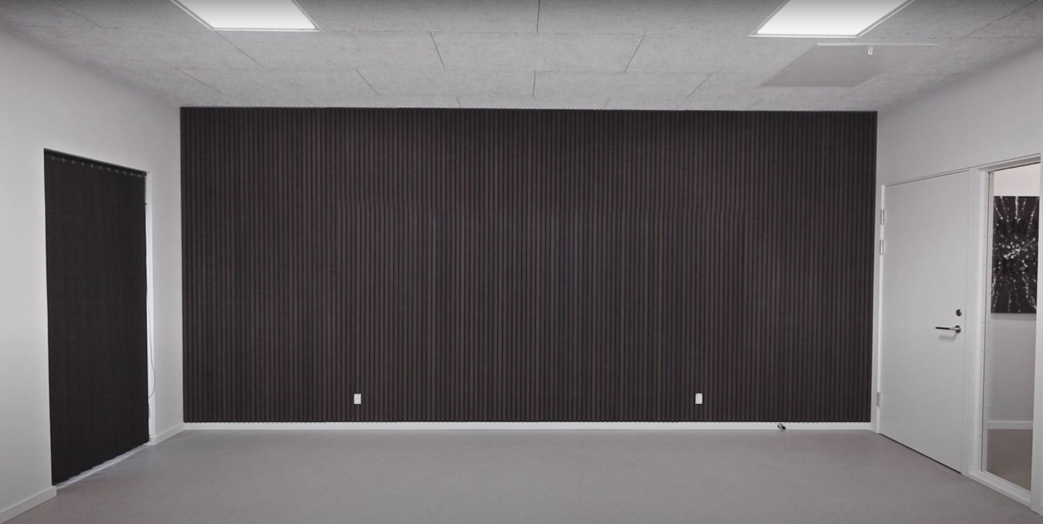 There is the acoustic wood wall panel in a room