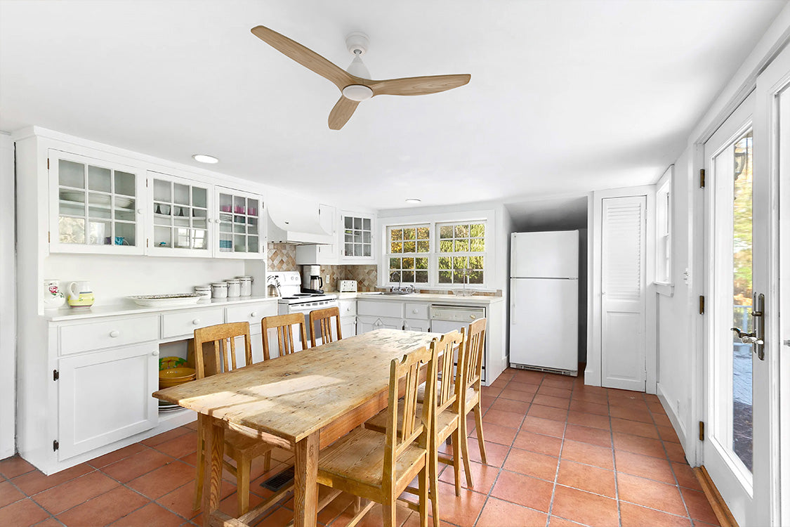Zircon 52-inch farmhouse style ceiling fan in rustic dining room with wood table and white walls.