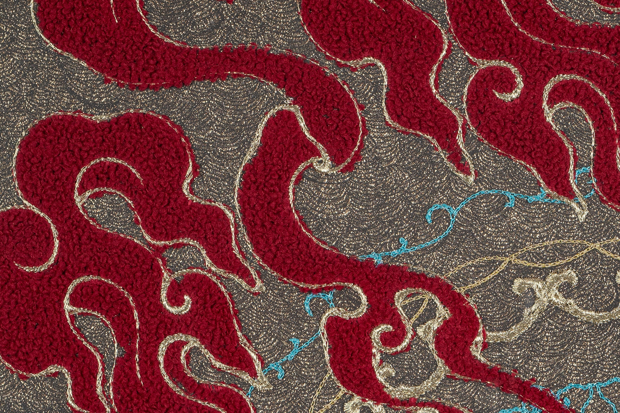 Detailed view of framed embroidery artwork featuring the ball design with fire and water elements.