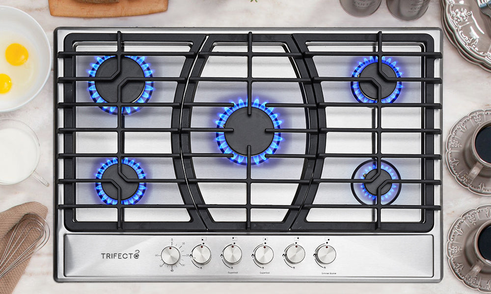 A  gas stove with five burners squirting with blue flame
