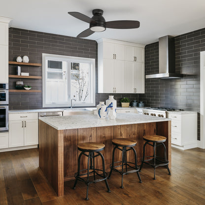 Thibault black ceiling fan with dimmable led light and remote designed in kitchen with modern wood grain elements. 