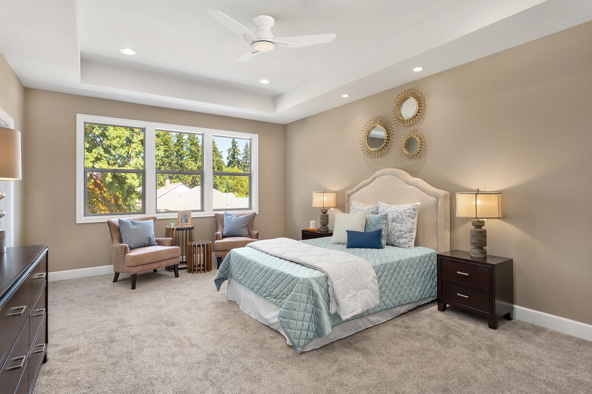 White Flush mount ceiling fan with remote and LED light is well matched to the mint green bed quilt and beige tones of the modern bedroom