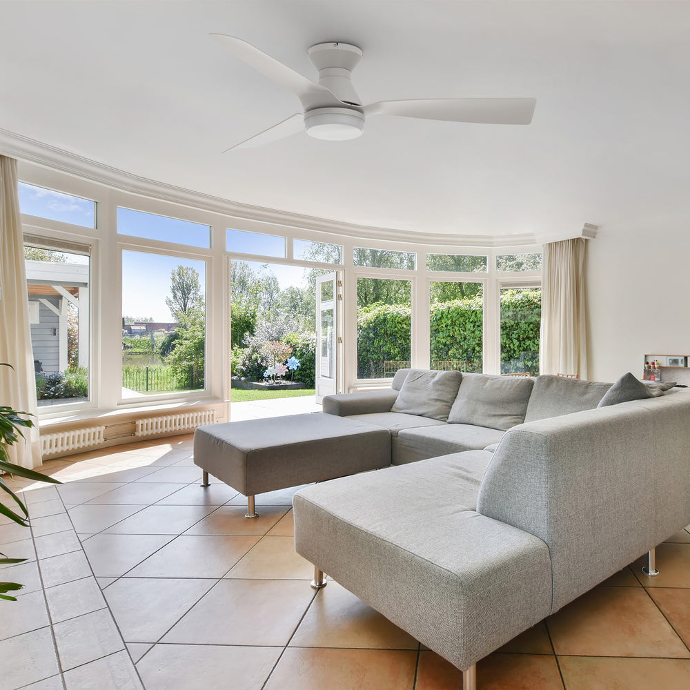 Low-profile remote ceiling fan matching with light grey linen U-shaped sofa, beige curtains and spacious bright large curved glass, make the living room design more advanced. 
