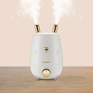 A cute humidifier designed to use rabbit ears as a nozzle is running and spraying moisture