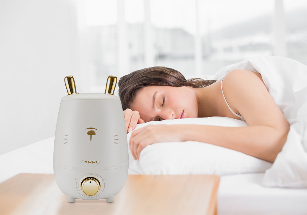 a women uses zukis ultrasonic humidifier to make herself sleep better