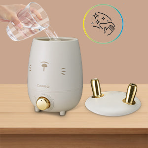 Top fill design ultrasonic humidifier is being added water, which is easy to clean.