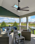 Outdoor ceiling fan ASPEN with 5 blades, in modern design, mounted on a slanted patio roof with an extended rod. 