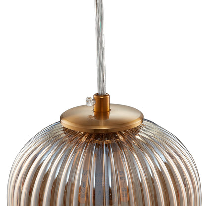 Smafan Cygnus Pendant Light Collection features a translucent elongated ribbed glass shade that creates an eye-catching glow. Hanging from a rich gold tone brass finish canopy that enhances its modern sophistication. Place over dining areas, seating areas, and more for a dramatic look. Its versatile look can complement most any room style. 