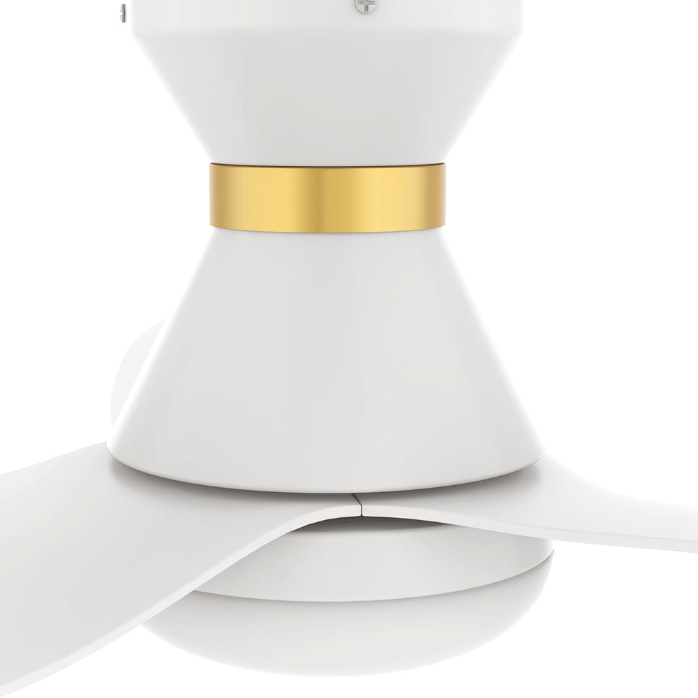A close-up view of a white and gold flush-mount smart ceiling fan, highlighting the motor housing with a gold accent ring and integrated light, with three white blades extending outward. 