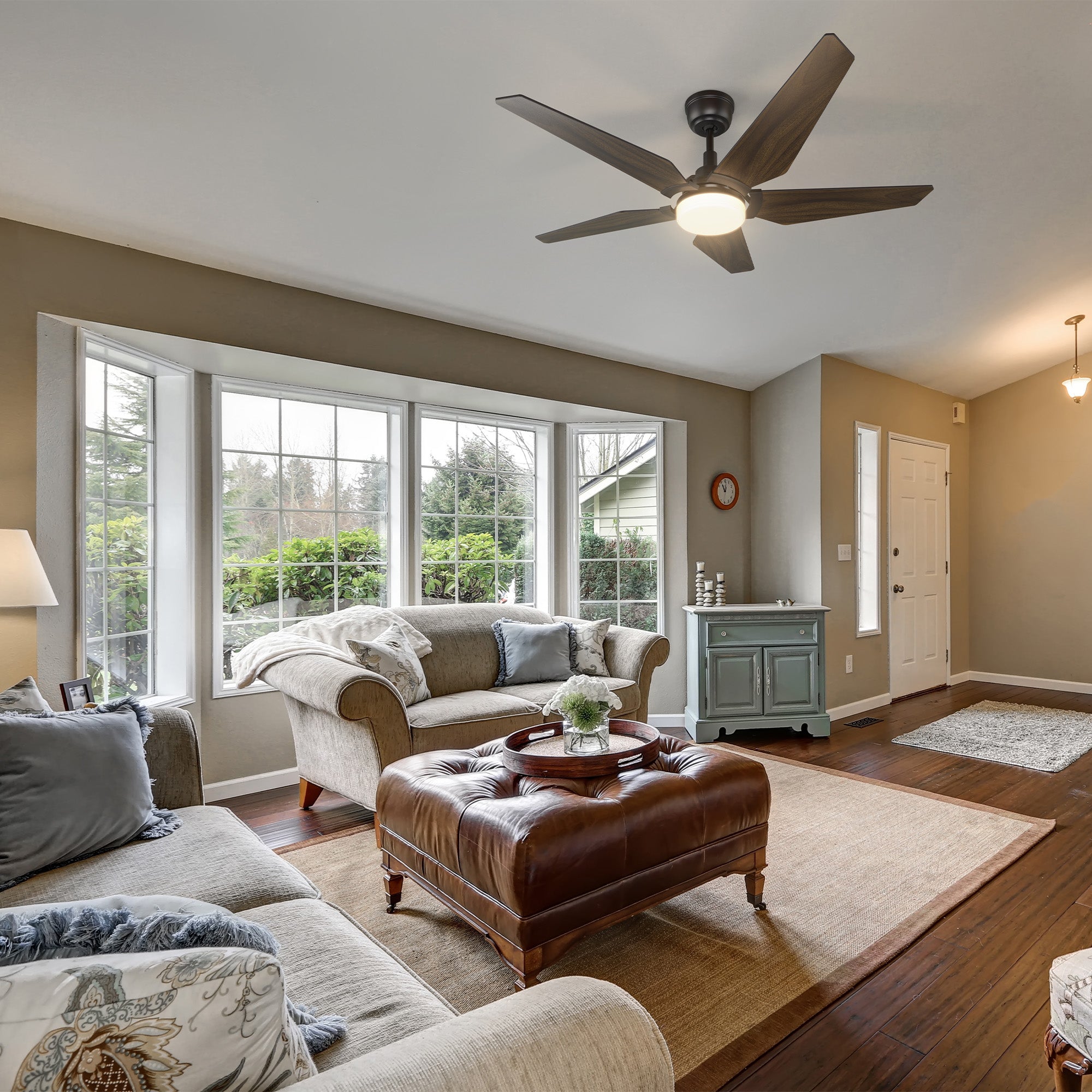 The Smafan Voyager 52" Smart WiFi Ceiling Fan enhances this cozy living room with a balance of modern function and timeless comfort. Its rich dark wood blades complement the warm tones of the space while providing quiet, energy-efficient airflow and soft LED lighting. Perfect for relaxing evenings or family gatherings, it adds style and smart convenience to your everyday comfort. 