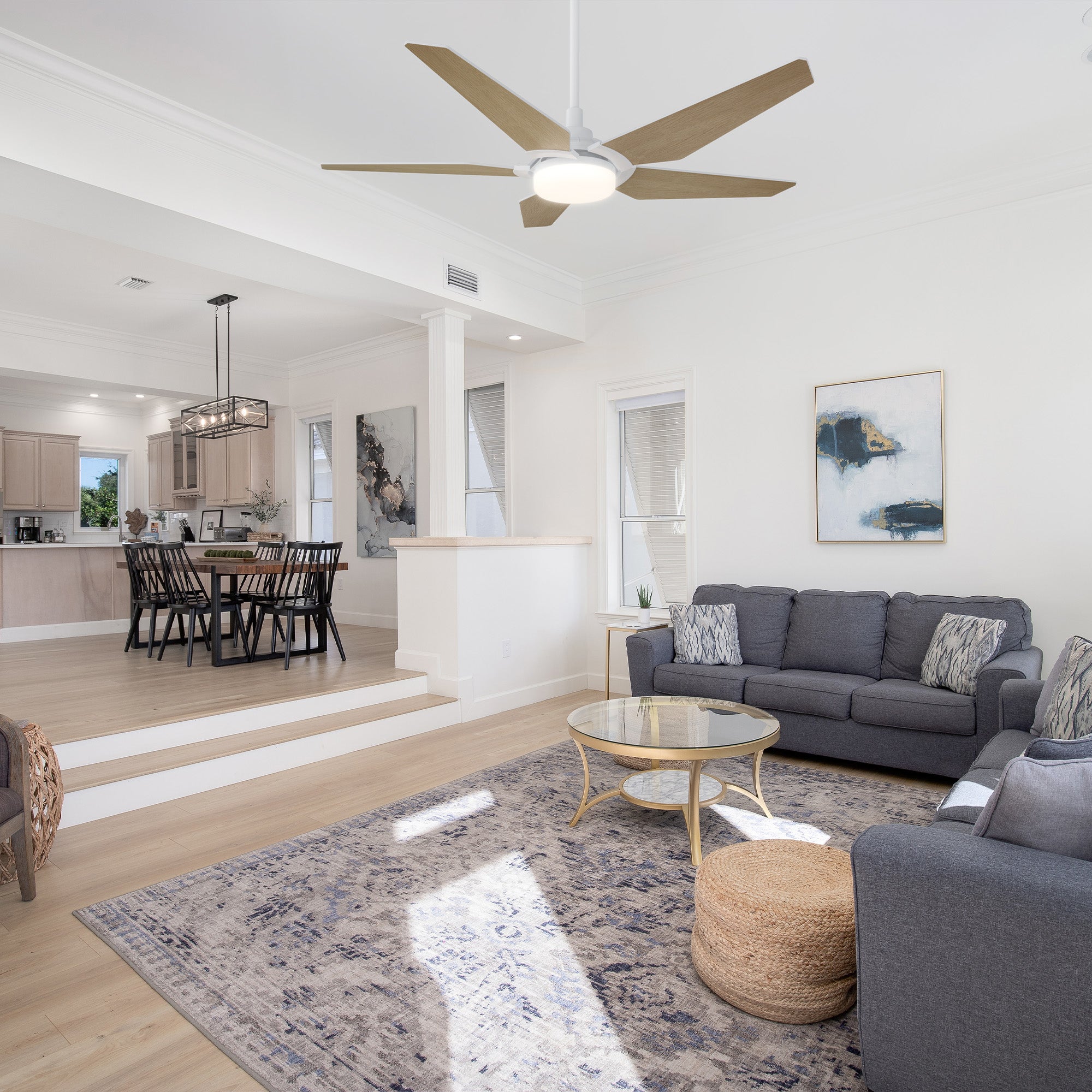 The Voyager 52" smart ceiling fan with light enhances this modern kitchen with its clean white finish and wood-toned blades. It provides powerful airflow and gentle illumination, creating a refreshing and inviting cooking space. 